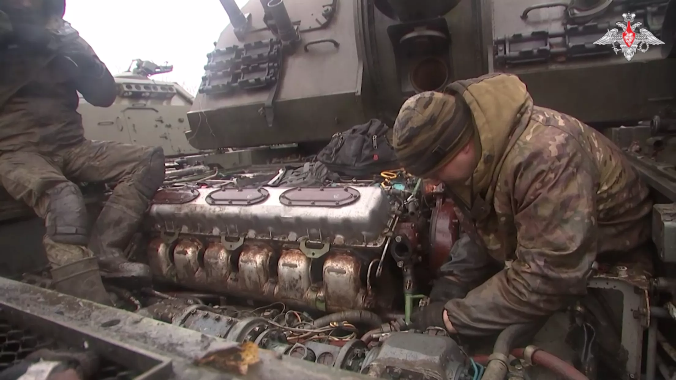 Russian troops repair an armored vehicle.