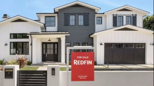 Redfin for sale sign in front of a house